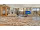 Open living room with sliding glass doors to balcony, neutral furniture and decorative built-in at 8779 Midnight Pass Rd # 506H, Sarasota, FL 34242