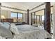 This main bedroom includes an ornamental bed frame and a large sliding glass door to the private balcony at 8779 Midnight Pass Rd # 506H, Sarasota, FL 34242