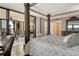This main bedroom includes an ornamental bed frame and a large sliding glass door to the private balcony at 8779 Midnight Pass Rd # 506H, Sarasota, FL 34242