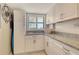 Pantry featuring ample cabinet space, granite countertops, and a window for natural light at 8779 Midnight Pass Rd # 506H, Sarasota, FL 34242