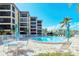 Community pool offers residents a refreshing escape with plenty of lounge chairs and patio seating at 8779 Midnight Pass Rd # 506H, Sarasota, FL 34242