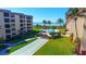 View of complex shuffleboard with a view of pool and beach at 8779 Midnight Pass Rd # 506H, Sarasota, FL 34242