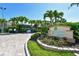 Island Reef entrance sign with lush landscaping, showing the address of the building at 8779 Midnight Pass Rd # 506H, Sarasota, FL 34242