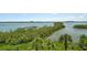 Enjoy wide water views from this property surrounded by lush tropical landscaping at 8779 Midnight Pass Rd # 506H, Sarasota, FL 34242