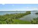 Panoramic water view featuring lush greenery and boat docks under a clear blue sky at 8779 Midnight Pass Rd # 506H, Sarasota, FL 34242