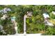Birds-eye view of the home, long driveway, and neighborhood, showing privacy and mature trees at 950 Trotter St, Nokomis, FL 34275