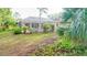 Landscaped backyard features a screened-in pool, patio, and lush green lawn at 950 Trotter St, Nokomis, FL 34275