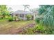 Lush backyard featuring a screened-in pool area and well-maintained landscaping for outdoor enjoyment at 950 Trotter St, Nokomis, FL 34275