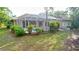 Landscaped backyard features a screened-in pool, patio, and lush green lawn at 950 Trotter St, Nokomis, FL 34275