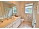 Well-maintained bathroom with a single sink vanity, toilet and shower-tub combination at 950 Trotter St, Nokomis, FL 34275