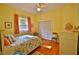 Bright bedroom with a ceiling fan, a window, and a bed with a beach-themed pillow at 950 Trotter St, Nokomis, FL 34275