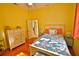 Bright bedroom featuring wood floors, colorful bedding, and natural light at 950 Trotter St, Nokomis, FL 34275