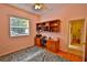 Cozy bedroom with hardwood floors, a ceiling fan, and a built-in desk at 950 Trotter St, Nokomis, FL 34275