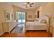 Light and airy bedroom with sliding doors to the pool, wood floors, and neutral decor at 950 Trotter St, Nokomis, FL 34275