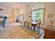 Open dining area with natural light, a decorative chandelier and a view of the front yard at 950 Trotter St, Nokomis, FL 34275