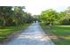 Long, gravel driveway leading to the main house, set back from the road at 950 Trotter St, Nokomis, FL 34275