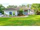 Charming home with well-manicured lawn, colorful landscaping, and an inviting double-door entryway at 950 Trotter St, Nokomis, FL 34275