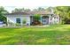 Well-maintained home with manicured lawn, vibrant landscaping, and a welcoming double-door entrance at 950 Trotter St, Nokomis, FL 34275