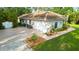 Well-maintained home featuring a spacious driveway, two car garage, and landscaped yard at 950 Trotter St, Nokomis, FL 34275