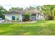 Charming single-story home with manicured lawn, colorful landscaping, and inviting double-door entrance at 950 Trotter St, Nokomis, FL 34275