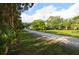 Long driveway leads to a secluded home nestled among lush greenery and mature trees at 950 Trotter St, Nokomis, FL 34275