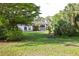 Charming home featuring a well-manicured lawn and lush, mature landscaping at 950 Trotter St, Nokomis, FL 34275