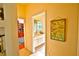 Hallway view of a bathroom with white cabinetry and a vanity mirror at 950 Trotter St, Nokomis, FL 34275