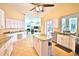 Open kitchen layout with island, stainless appliances, and tile flooring at 950 Trotter St, Nokomis, FL 34275