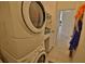 Stacked washer and dryer in tiled laundry room at 950 Trotter St, Nokomis, FL 34275