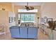 Bright living room features high ceilings, tile floors, and a view of the pool at 950 Trotter St, Nokomis, FL 34275