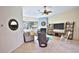 Bright living room featuring tiled flooring, a fireplace, and a large television at 950 Trotter St, Nokomis, FL 34275