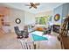 Cozy living room with a fireplace, tile flooring and natural lighting at 950 Trotter St, Nokomis, FL 34275
