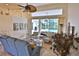 Bright living room with high ceilings, comfortable seating, and view of outdoor pool area at 950 Trotter St, Nokomis, FL 34275