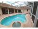 Screened-in pool area with a fountain and outdoor seating, perfect for relaxation at 950 Trotter St, Nokomis, FL 34275
