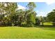 Beautiful view of the yard, showcasing lush greenery, mature trees, and well-maintained landscaping at 950 Trotter St, Nokomis, FL 34275