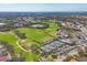 Expansive aerial view featuring a golf course, tennis courts, swimming pool, and clubhouse at 9630 Club South Cir # 6303, Sarasota, FL 34238