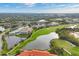 Expansive aerial view showcasing the community's beautiful golf course, lakes, and residential buildings at 9630 Club South Cir # 6303, Sarasota, FL 34238