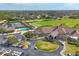 Aerial view of the clubhouse featuring golf course, pool, tennis courts and parking area at 9630 Club South Cir # 6303, Sarasota, FL 34238