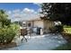 Backyard patio featuring outdoor seating, a grill, and partial view of a screened-in pool area at 9630 Club South Cir # 6303, Sarasota, FL 34238