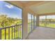 Spacious balcony with serene views of lush greenery, a golf course and clear blue skies at 9630 Club South Cir # 6303, Sarasota, FL 34238