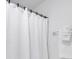 Bright bathroom features a white waffle-weave shower curtain and neatly folded white towels on a rack at 9630 Club South Cir # 6303, Sarasota, FL 34238