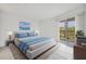 Sun-filled bedroom with a walkout balcony, and a clean, crisp color palette at 9630 Club South Cir # 6303, Sarasota, FL 34238