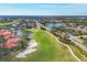 High-angle view of the expansive golf course, complete with water hazards, sand traps and views of residential properties at 9630 Club South Cir # 6303, Sarasota, FL 34238