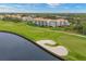 Scenic view of the golf course and building in a lush green community at 9630 Club South Cir # 6303, Sarasota, FL 34238