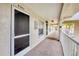 Exterior condo hallway featuring a secured entrance, carpeted floors, and a view of palm trees at 9630 Club South Cir # 6303, Sarasota, FL 34238