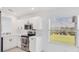 Well-lit kitchen with stainless steel appliances and a view of the landscaped backyard and water at 9630 Club South Cir # 6303, Sarasota, FL 34238