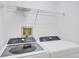 Laundry room with front load washer and dryer units and overhead storage racks at 9630 Club South Cir # 6303, Sarasota, FL 34238
