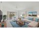 Bright living room with neutral walls, decor, and tile floors, with a sliding glass door to the patio at 9630 Club South Cir # 6303, Sarasota, FL 34238