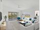 Bright living room featuring a ceiling fan, sliding glass doors to a balcony, and comfortable seating arrangement at 9630 Club South Cir # 6303, Sarasota, FL 34238