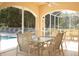 Covered patio with dining table overlooking a pool area, providing an inviting outdoor space at 9630 Club South Cir # 6303, Sarasota, FL 34238